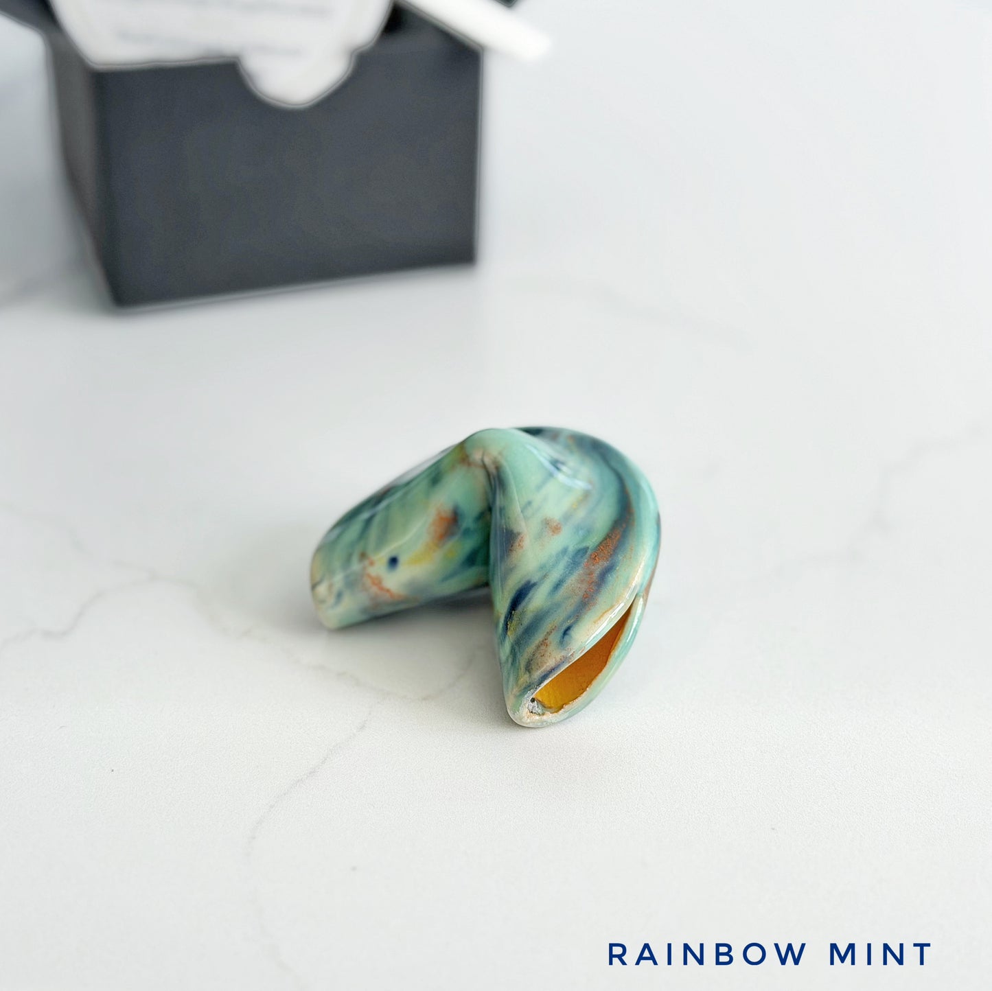 Mint and drippy glaze on a ceramic fortune cookie, handmade and glazed by hand in Wilmington, NC by Kathleen Kalish Ceramics.