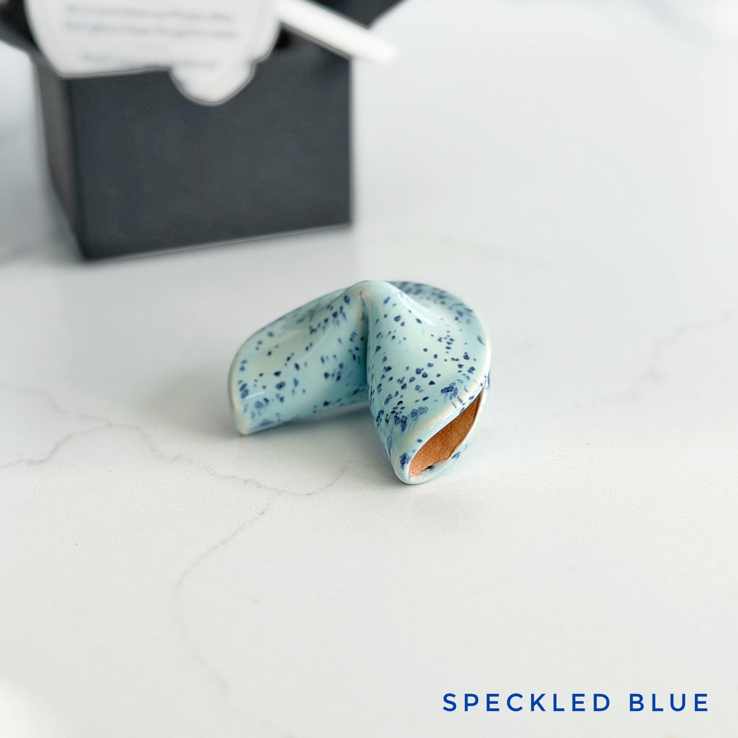 Blue speckled ceramic fortune cookie, handmade and glazed by hand in Wilmington, NC by Kathleen Kalish Ceramics.